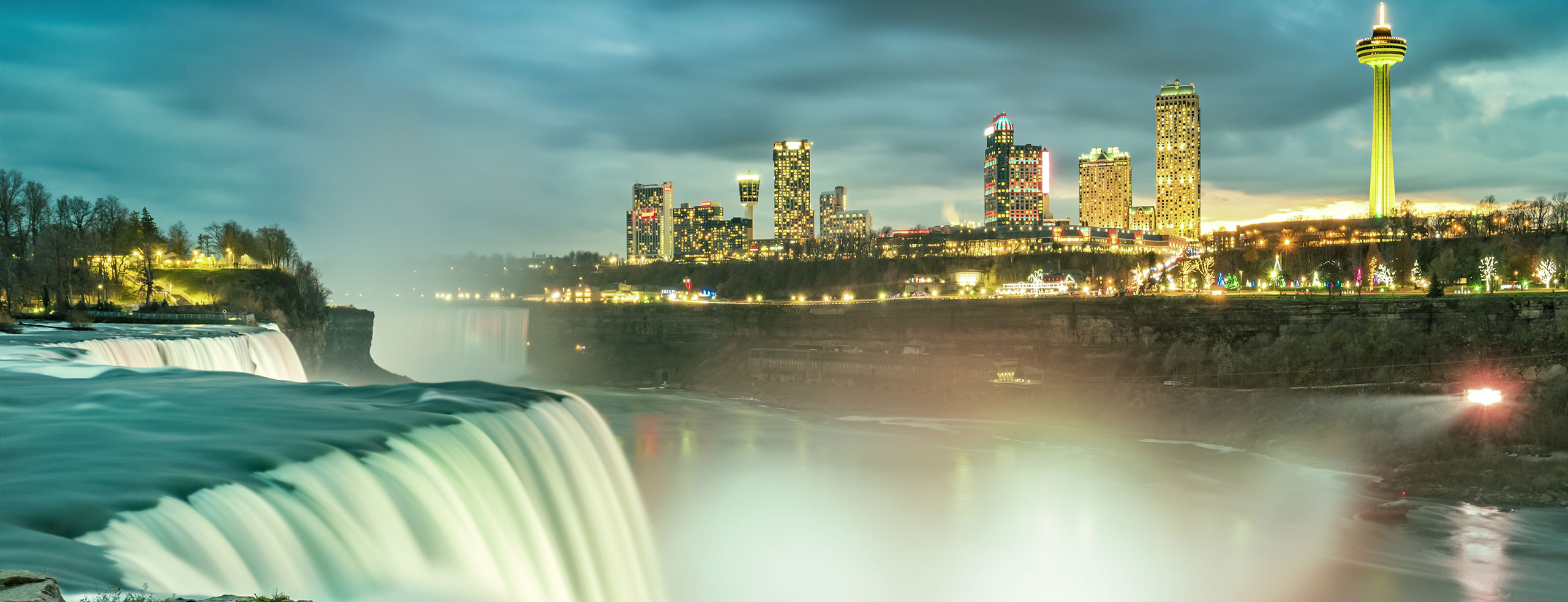 The city of Niagara Falls, Ontario, Canada at night beside the falls